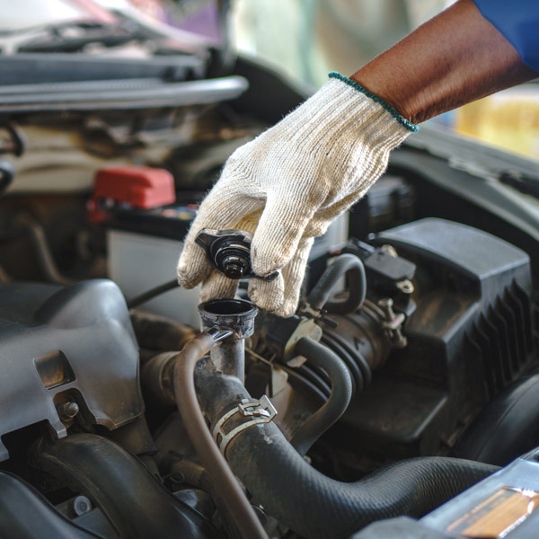 mechanic removing radiator cap